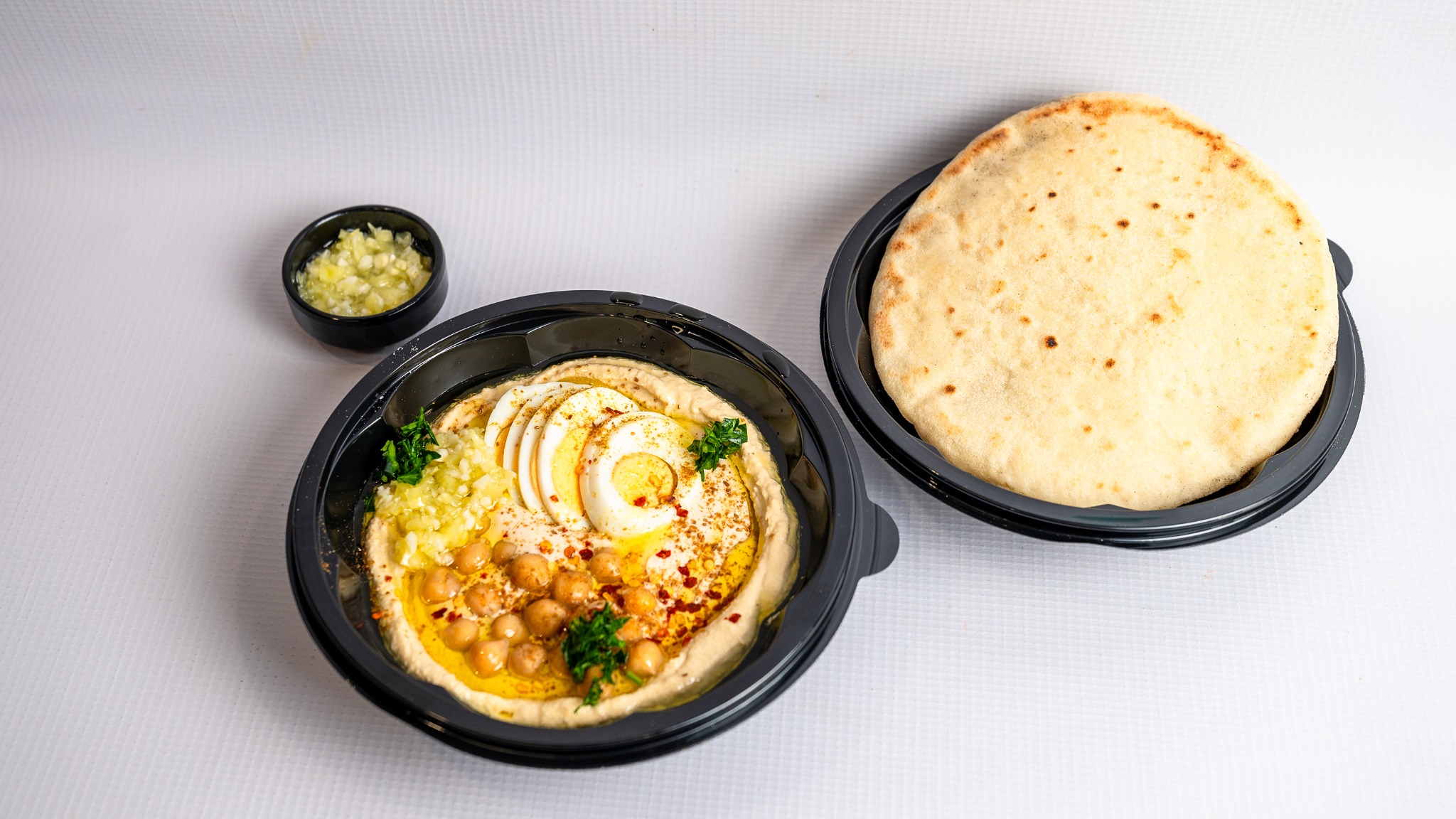 Hummus and egg bowl served with pita