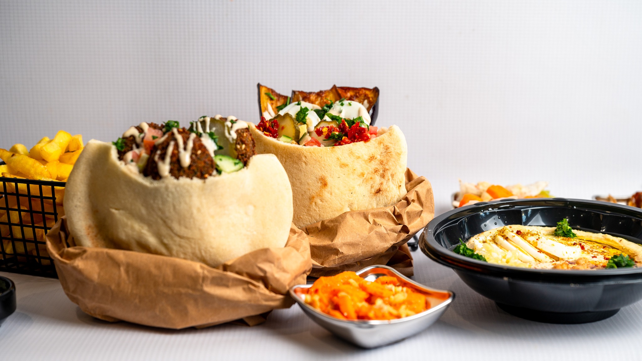 A closer view of falafel, sabich, hummus and salads